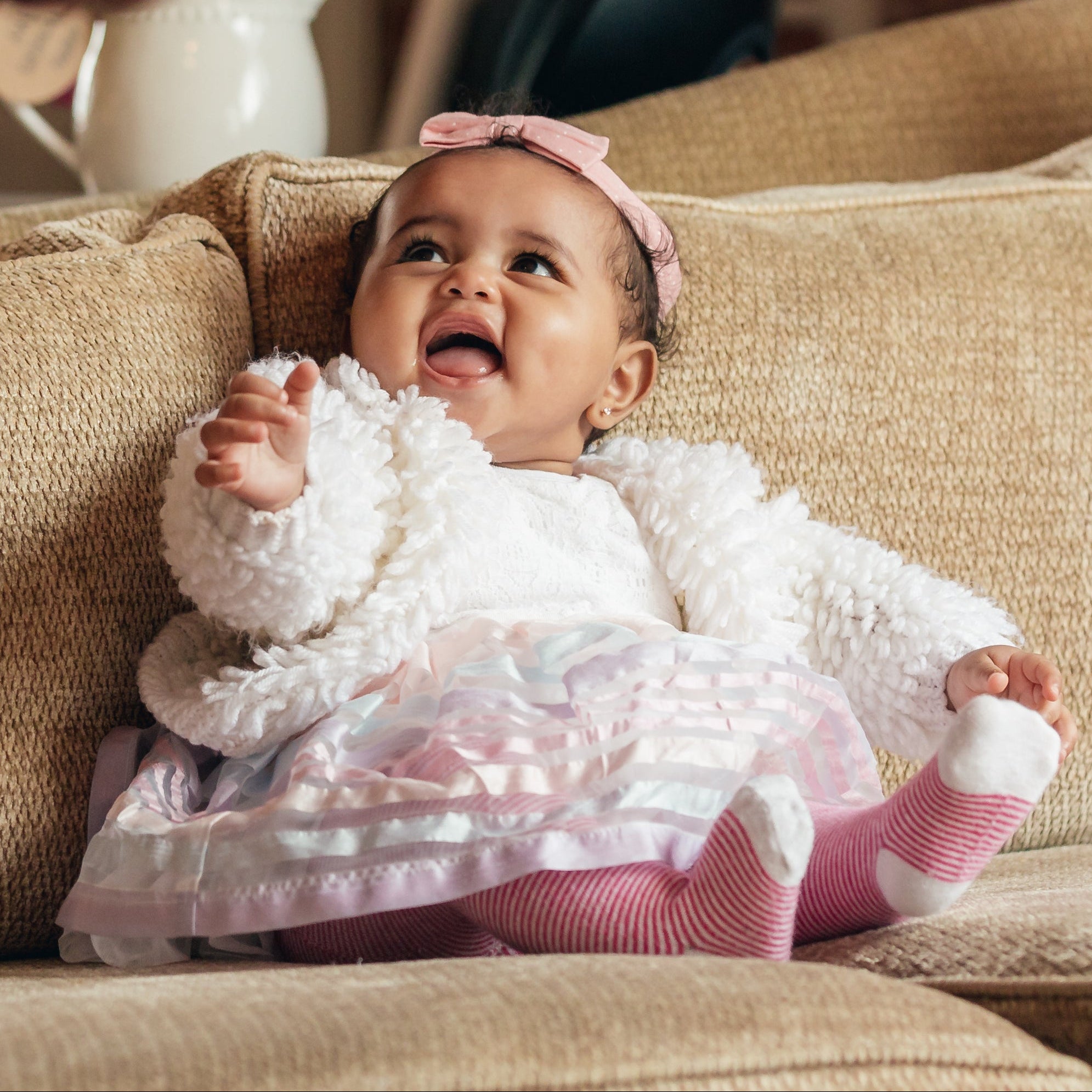 files/baby-girl-on-couch-lookingat-dad-smiling.jpg